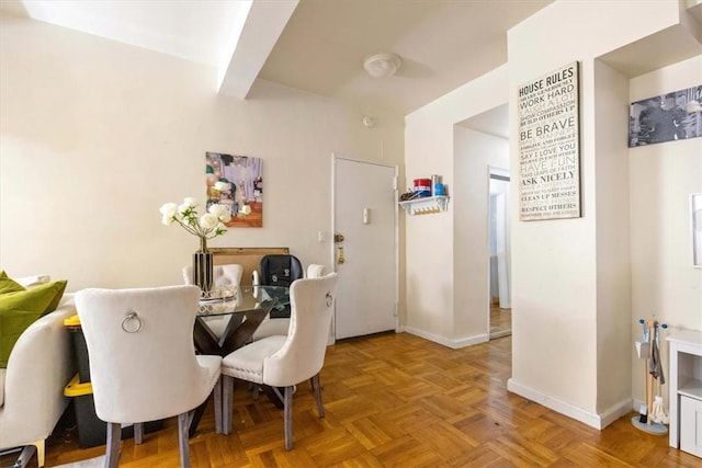 dining space with light parquet flooring