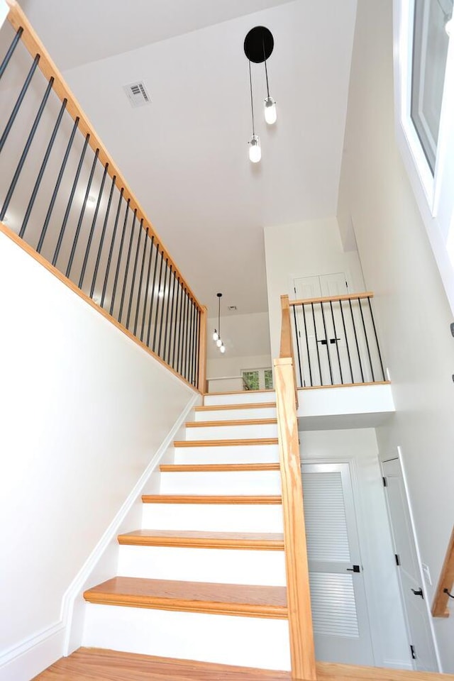 stairway with hardwood / wood-style flooring