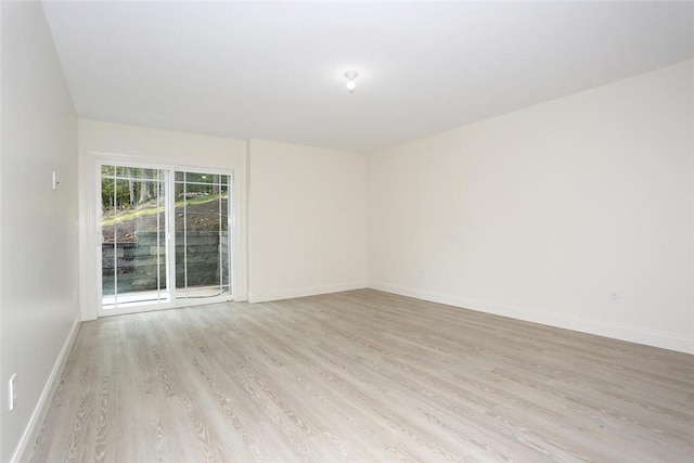 unfurnished room with light hardwood / wood-style flooring