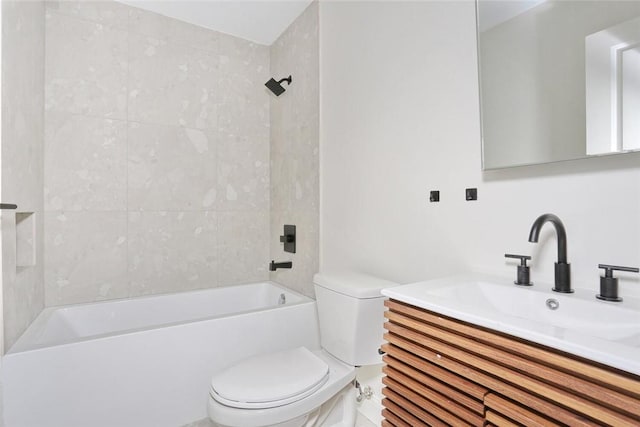 full bathroom with vanity, tiled shower / bath combo, and toilet