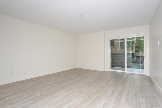 spare room featuring light wood-type flooring