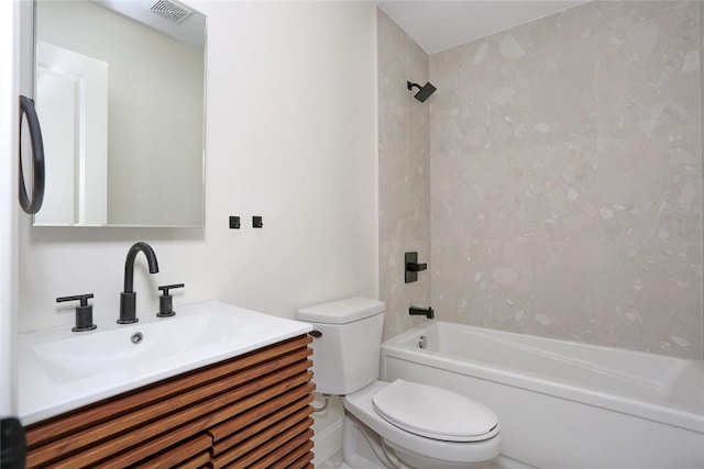 full bathroom with vanity, tiled shower / bath combo, and toilet