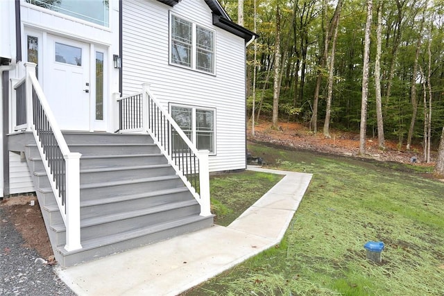 entrance to property with a lawn