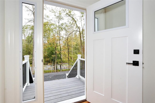 doorway to outside with a wealth of natural light and hardwood / wood-style flooring