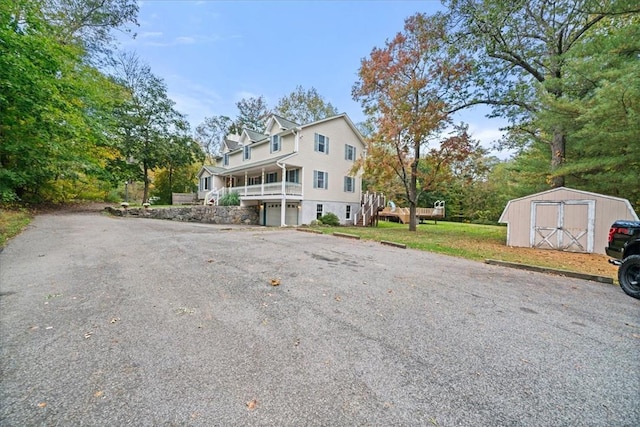 front of property featuring a storage shed and a front lawn