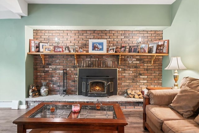 living room featuring wood-type flooring and a wood stove