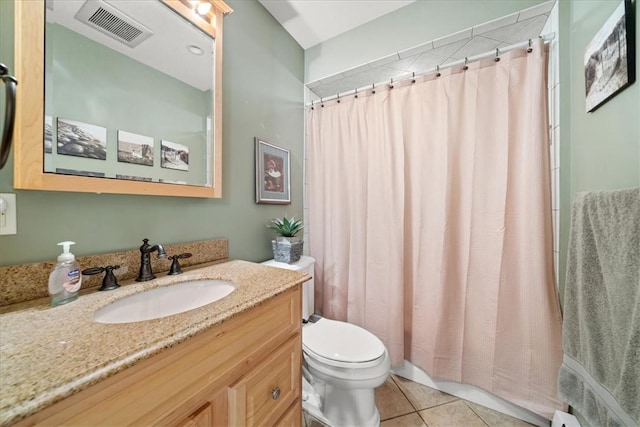 bathroom featuring tile patterned flooring, vanity, and toilet