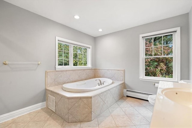 bathroom with vanity, a baseboard radiator, tile patterned floors, and tiled tub