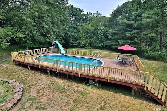 view of pool featuring a wooden deck and a water slide