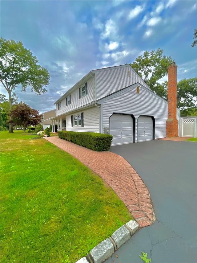 view of front of house with a front yard and a garage