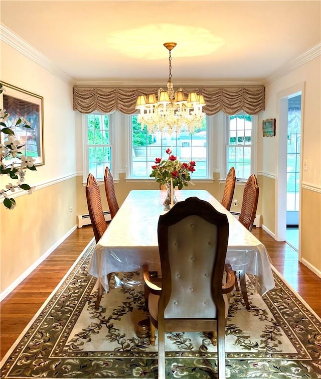 dining room with a wealth of natural light, an inviting chandelier, dark hardwood / wood-style floors, and ornamental molding