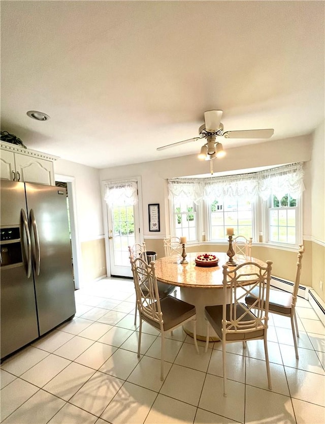 tiled dining room with ceiling fan and a wealth of natural light