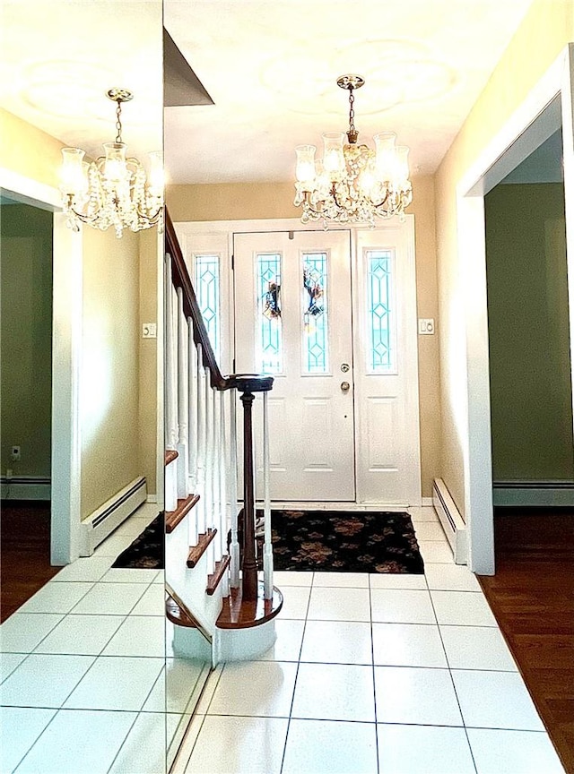 foyer with plenty of natural light, light hardwood / wood-style flooring, a baseboard radiator, and an inviting chandelier