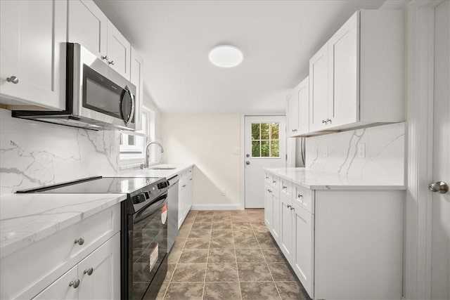 kitchen featuring decorative backsplash, white cabinetry, and stainless steel appliances