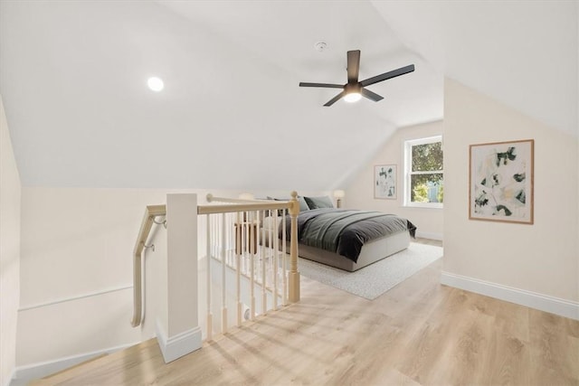 bedroom featuring light hardwood / wood-style floors, ceiling fan, and lofted ceiling