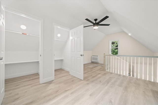 bonus room with a wall mounted AC, ceiling fan, light hardwood / wood-style floors, and lofted ceiling