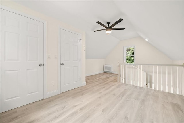 bonus room with ceiling fan, light wood-type flooring, a wall unit AC, and lofted ceiling