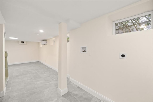 clothes washing area with washer hookup, a wall mounted air conditioner, and hookup for an electric dryer