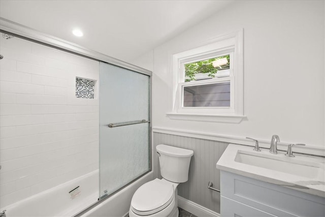 full bathroom with vanity, enclosed tub / shower combo, and toilet