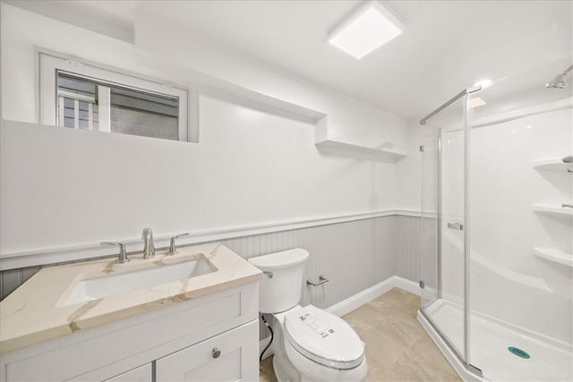 bathroom featuring toilet, vanity, and walk in shower