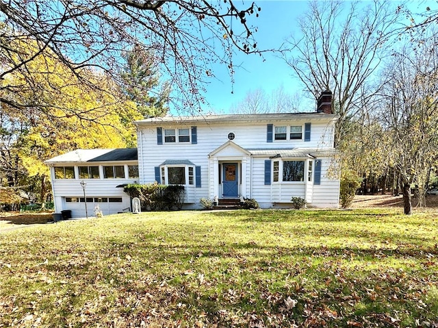 view of front facade with a garage, a front lawn, and a sunroom