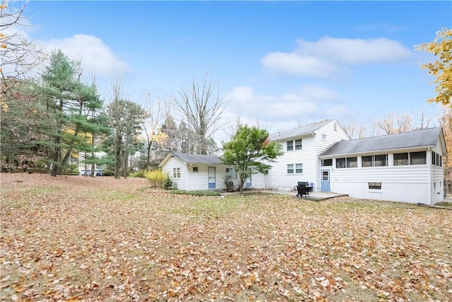 back of property with a patio and a sunroom