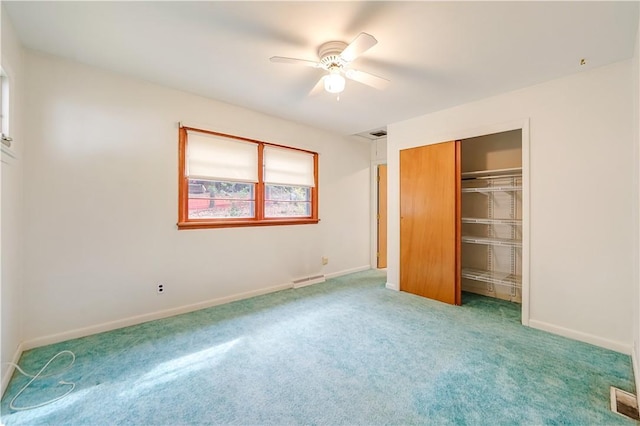 unfurnished bedroom with a closet, ceiling fan, and carpet floors