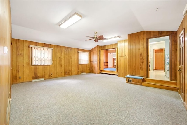 unfurnished room featuring ceiling fan, light carpet, and lofted ceiling