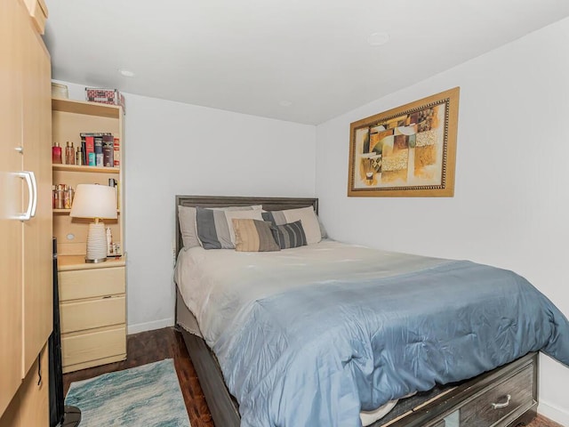 bedroom featuring dark hardwood / wood-style flooring