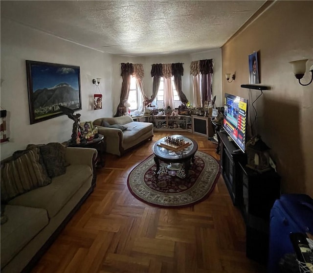 living room featuring parquet floors and a textured ceiling