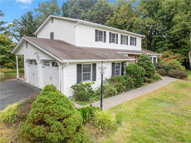 exterior space featuring a front lawn and a garage