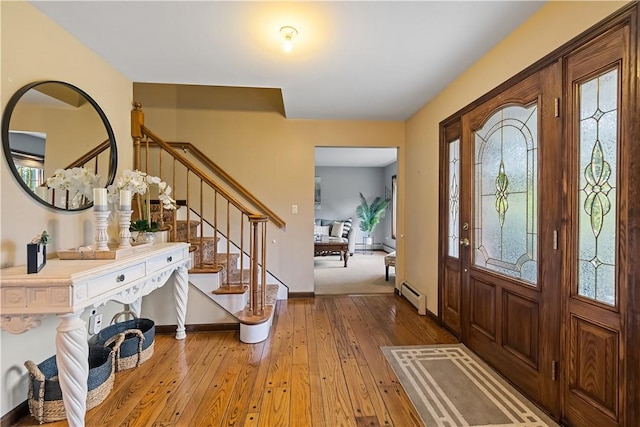 foyer with hardwood / wood-style floors and a baseboard radiator