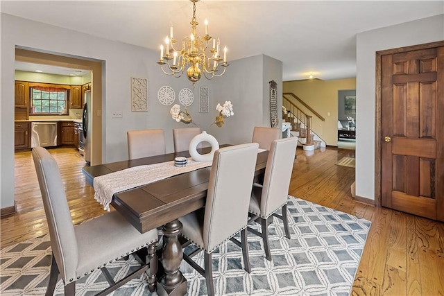 dining room featuring light hardwood / wood-style floors and a chandelier