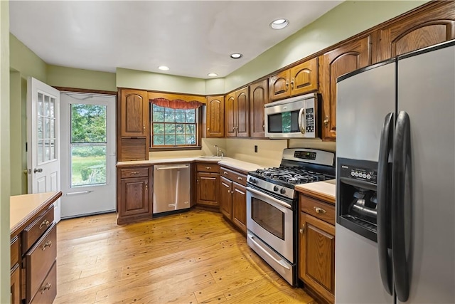 kitchen with light wood-type flooring and stainless steel appliances