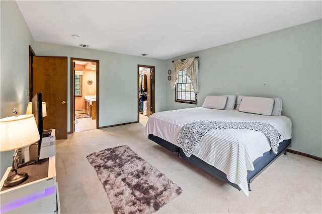 carpeted bedroom with connected bathroom, a spacious closet, and a closet