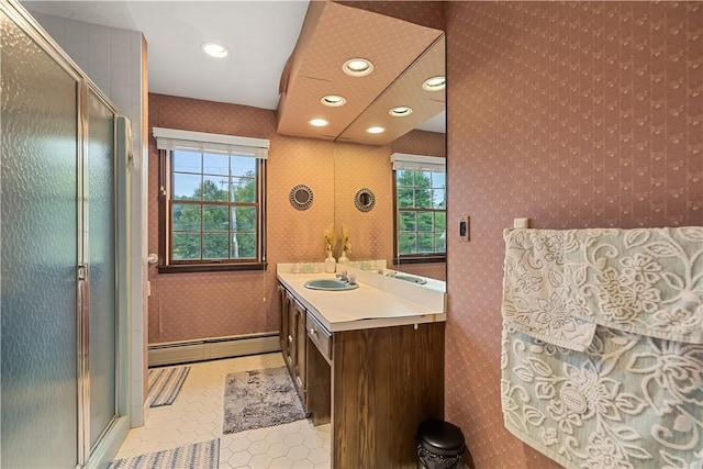 bathroom with tile patterned floors, vanity, an enclosed shower, and a baseboard radiator