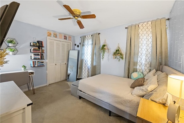 bedroom with ceiling fan, light colored carpet, and a closet