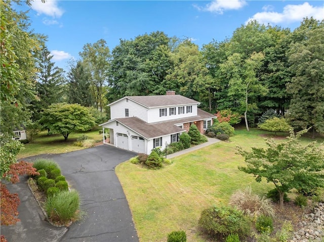 view of front of property featuring a garage and a front lawn