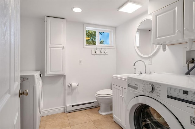 bathroom with tile patterned floors, sink, toilet, a baseboard radiator, and washing machine and clothes dryer