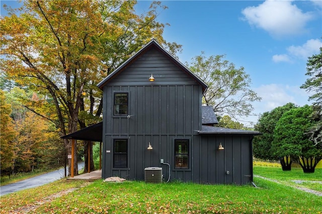 view of home's exterior featuring a yard and central AC unit