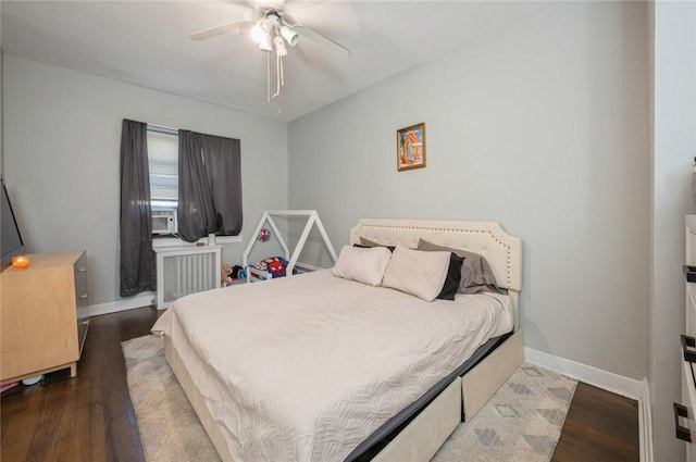 bedroom with hardwood / wood-style floors, ceiling fan, and radiator heating unit