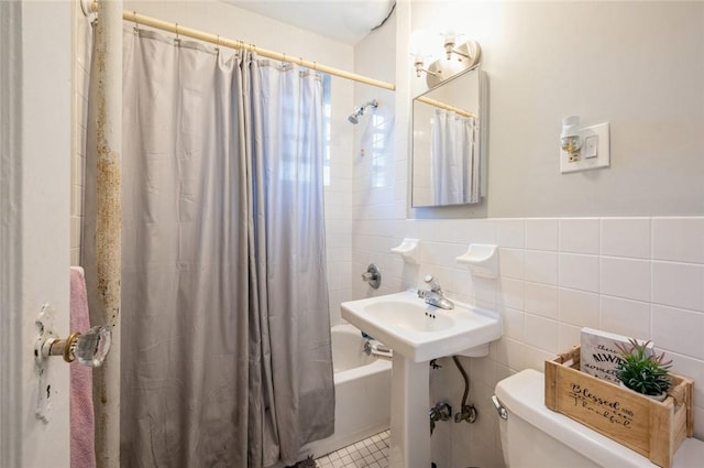 full bathroom with sink, shower / bathtub combination with curtain, tile walls, tile patterned flooring, and toilet