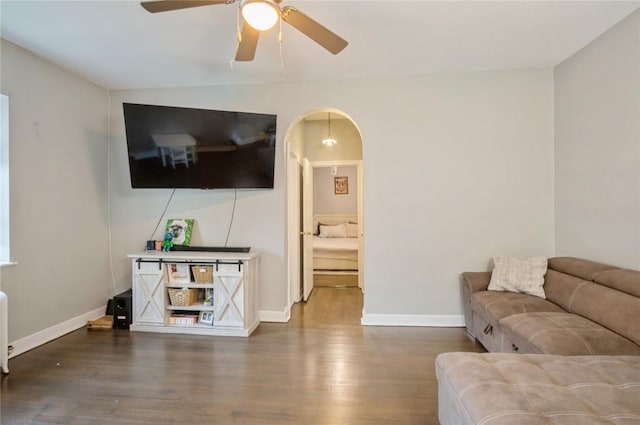 living room with hardwood / wood-style flooring and ceiling fan