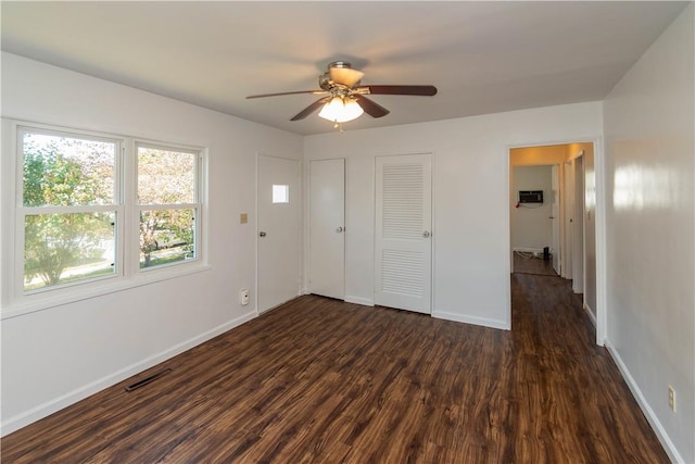 unfurnished bedroom with ceiling fan and dark hardwood / wood-style flooring