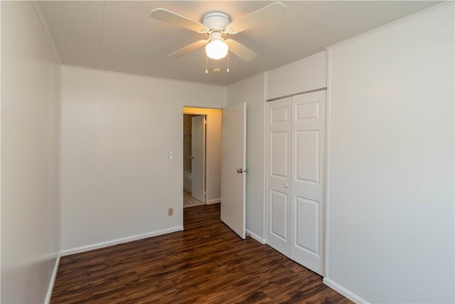 unfurnished bedroom with a closet, ceiling fan, and dark hardwood / wood-style flooring