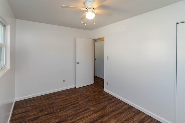 empty room featuring ceiling fan and dark hardwood / wood-style flooring