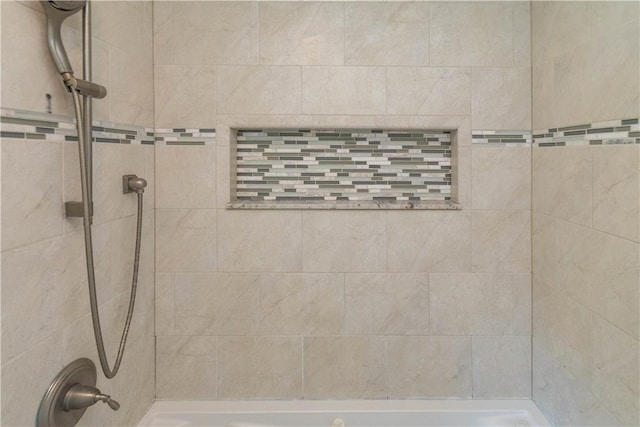 bathroom with tiled shower