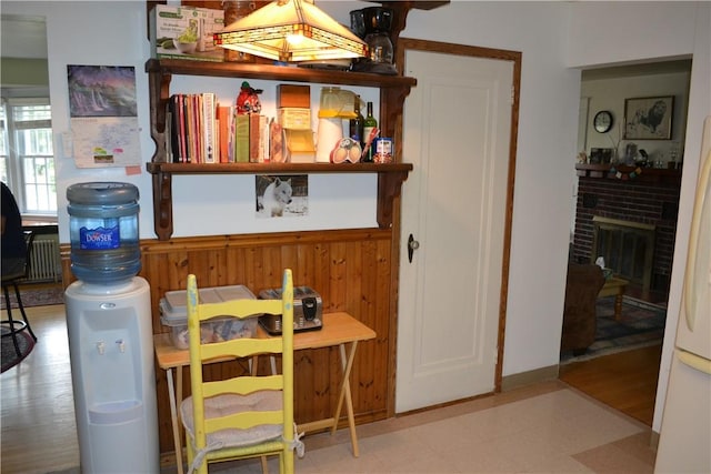 interior space featuring a fireplace, wood-type flooring, and radiator heating unit