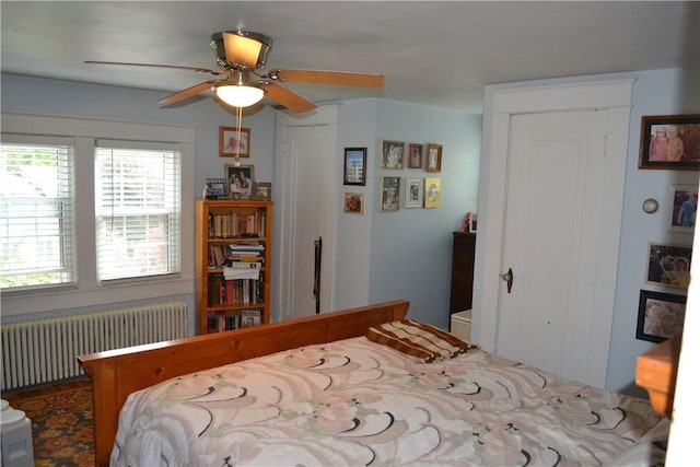 bedroom with radiator heating unit and ceiling fan