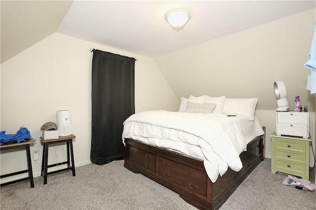 bedroom with light colored carpet and lofted ceiling